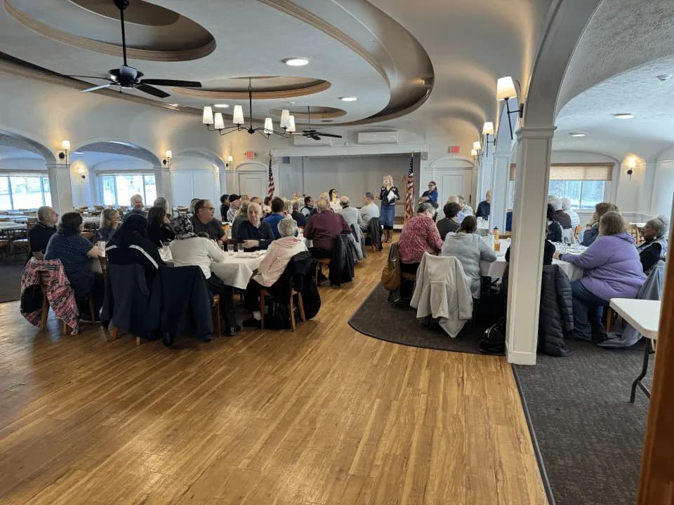 A large corporate meeting in the main ballroom