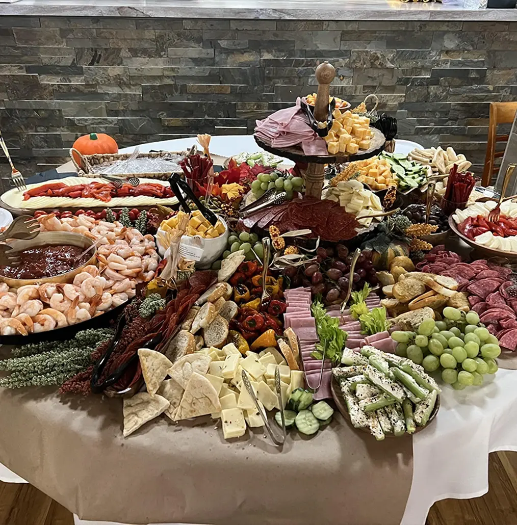 Elaborate charcuterie display with meats, cheeses, shrimp, fruits and vegetables at Barnard Hall